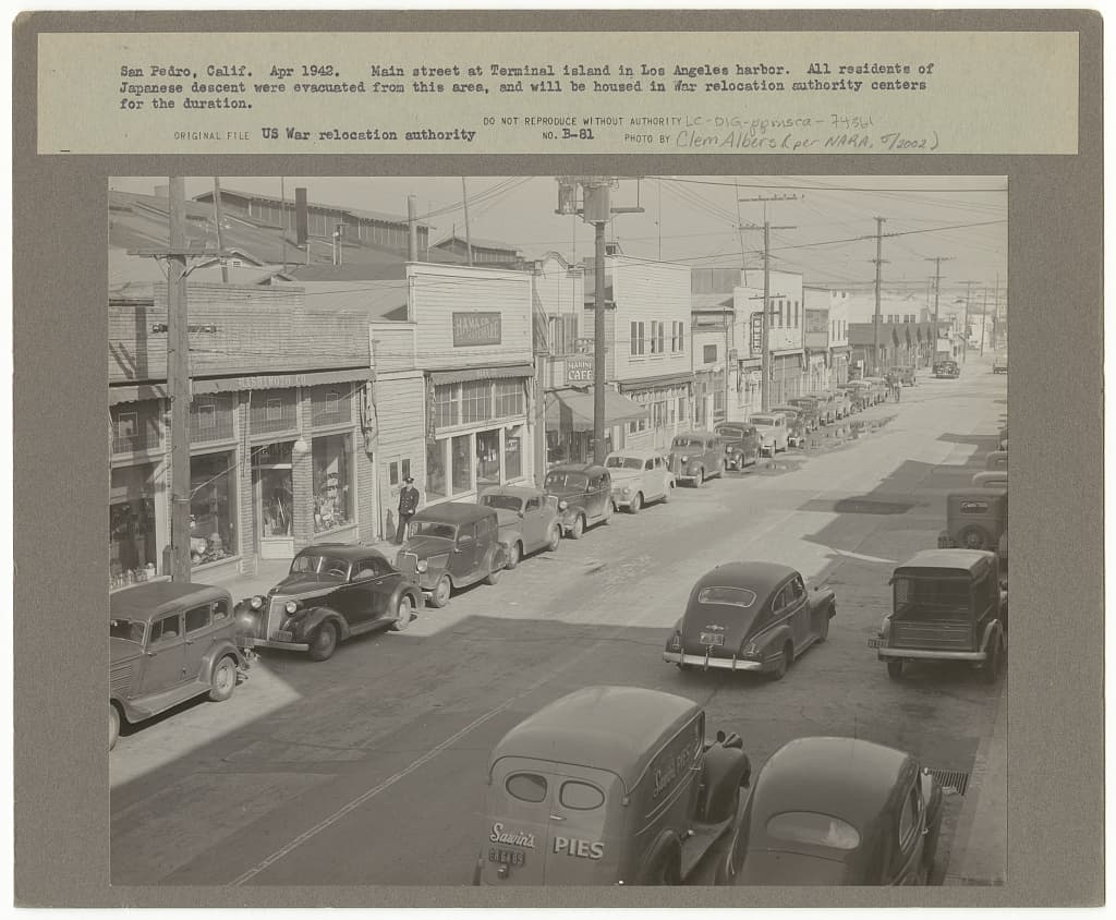 Tuna Street, the main commercial strip of the Japanese-American village of Furusato on Terminal Island in Los Angeles Harbor, photographed in April 1942 as the federal evacuation orders took effect.